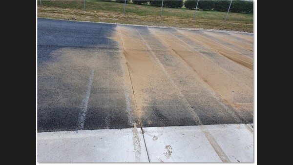 The researchers cut slots into the asphalt base layer to simulate existing cracks.