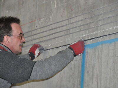 Insertion of the laminates into the adhesive filled slots