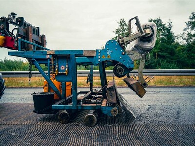 Asphalt reinforcement machine in action