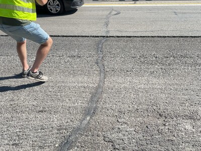 Crack running across road width